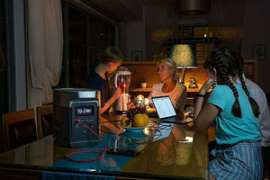 EcoFlow DELTA 1300 Portable Power Station in use, powering multiple devices on a dining table.