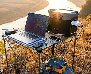 EcoFlow DELTA 1300 Portable Power Station on outdoor table, powering multiple devices.