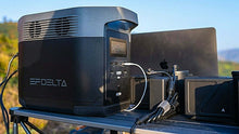 Load image into Gallery viewer, EcoFlow DELTA 1300 Portable Power Station on outdoor table, charging devices.
