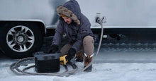 Load image into Gallery viewer, Man using EcoFlow DELTA 1300 Portable Power Station in snow.
